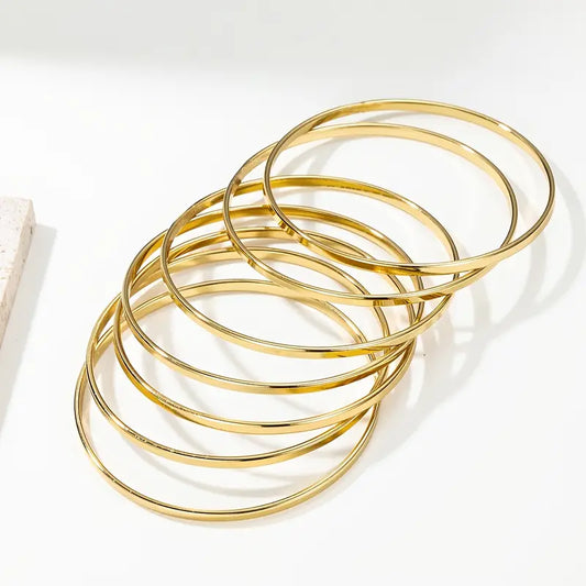 Bracelet 7 joncs dorés – CXL by Christian Lacroix